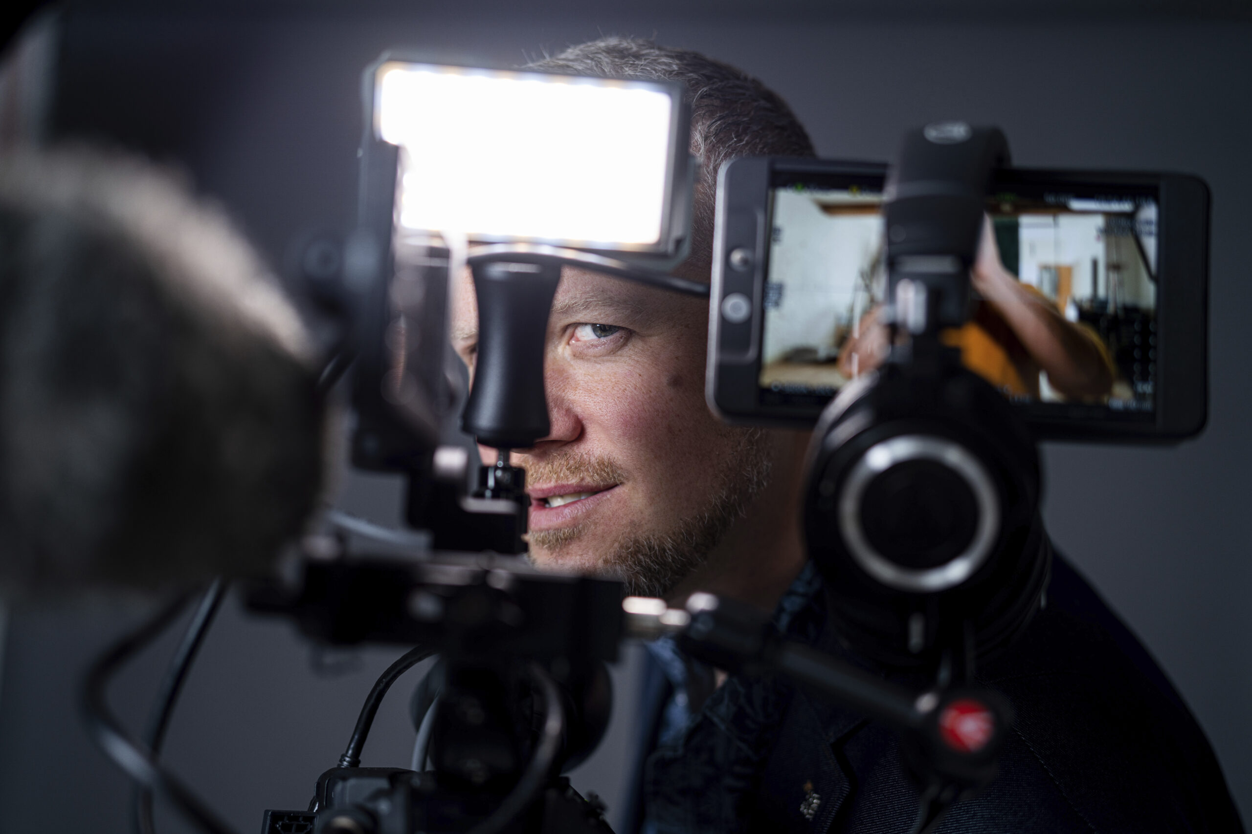 Man posing in front of photographic equipment